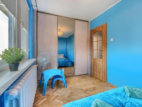 a bedroom with a blue bed and a blue chair at Platinium Wrzeszcz - Batorego in Gdańsk