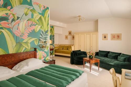a bedroom with a bed and a living room with a couch at Grand Hotel Villa Serbelloni - A Legendary Hotel in Bellagio