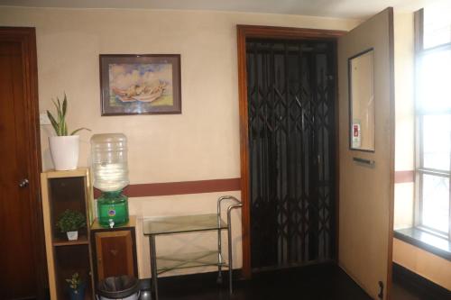 a room with a door and a table and a window at SHIVANGAN HOTEL and BANQUET in kolkata