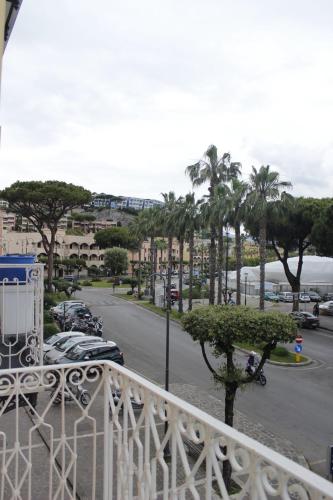 a balcony with a view of a street and palm trees at B&B Anema'e Core in Gaeta