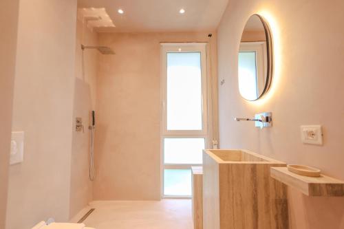 a bathroom with a sink and a mirror at SanPietro Vacation Apartments in Durrës
