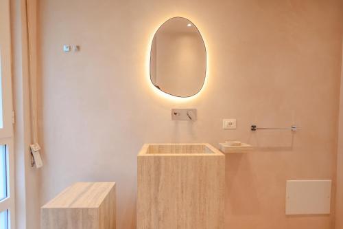 a bathroom with a wooden sink and a mirror at SanPietro Vacation Apartments in Durrës
