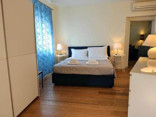 a bedroom with a bed with two towels on it at L'Opera Rooms & Suite in La Spezia
