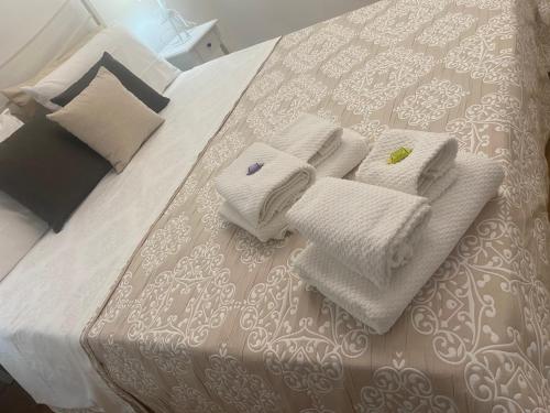 a bed with white towels and pillows on it at Casa AnnaPaola Luxury in Chioggia