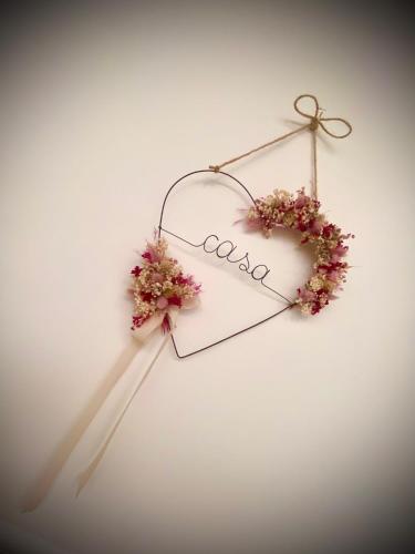 a heart shaped sign with flowers on a wall at Casa AnnaPaola Luxury in Chioggia