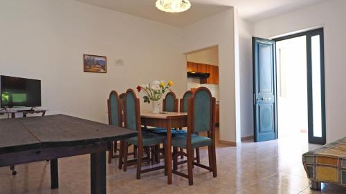 a dining room with a table and chairs at Appartamenti Torre Suda by Salento Affitti in Torre Suda