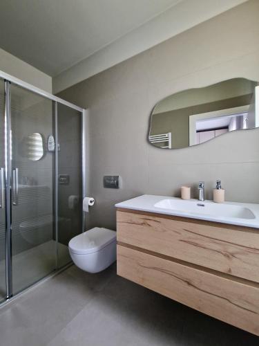 a bathroom with a sink and a toilet and a shower at La Vela Luxury Apartment in Pescara