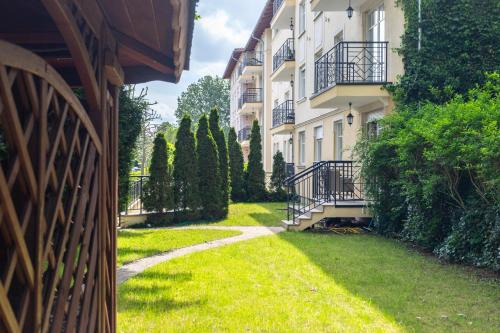 a walkway between two buildings in a yard at Victus Apartamenty, Patio Spa in Sopot