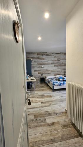 a room with a bed and a hallway with a door at Il Gaudente B&B in Santa Fiora
