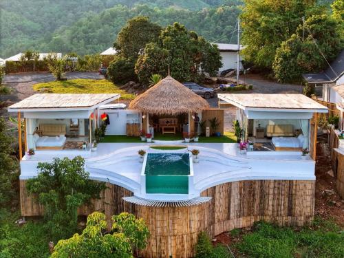 an aerial view of a house with a swimming pool at ไนท์สกาย โฮมสเตย์ in Ban Mae Na