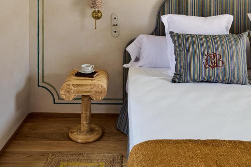 a bed with a side table with a cup on it at Cristine Bedfor Málaga in Málaga