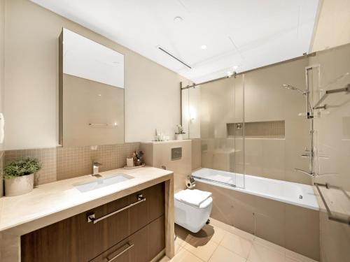 a bathroom with a sink and a toilet and a shower at The Dubai Mall Suite Luxury 1-Bed Near Burj Khalifa in Dubai