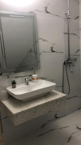 a bathroom with a sink and a mirror at Oriente Sole in Dhërmi