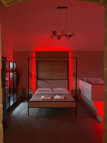 a bedroom with a bed with red lighting at Thaleia Suite & Spa in Palermo
