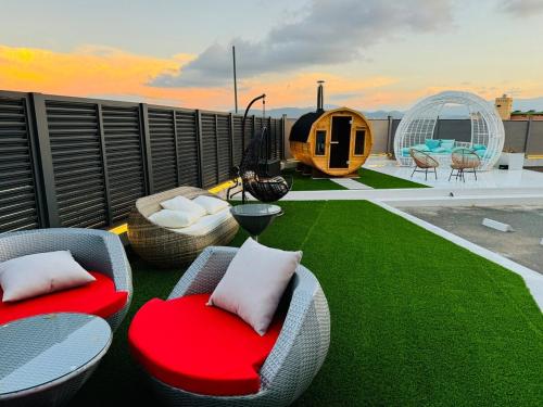 a patio with chairs and tables on a roof at Luxury Hills 1500ｍ2超絶景パティオ サウナ BBQ 駐車場4台 プール ペット 空港そば in Fukuoka