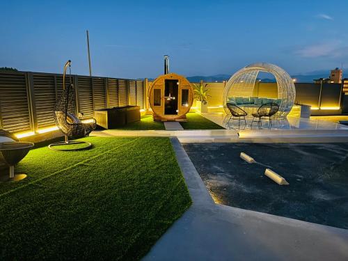a backyard with two chairs and a swing at Luxury Hills 1500ｍ2超絶景パティオ サウナ BBQ 駐車場4台 プール ペット 空港そば in Fukuoka