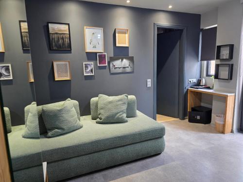 a living room with a couch and pictures on the wall at Be My Guest Athens in Athens