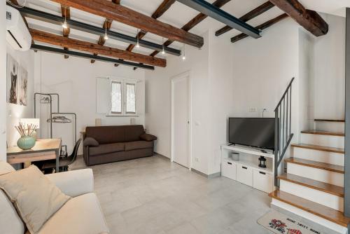 a living room with a couch and a tv at VISTALAGO VERSILIA in Massarosa
