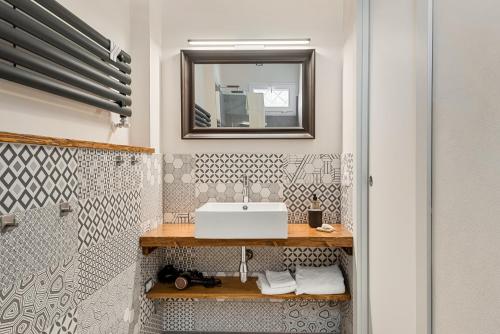a bathroom with a sink and a mirror at VISTALAGO VERSILIA in Massarosa