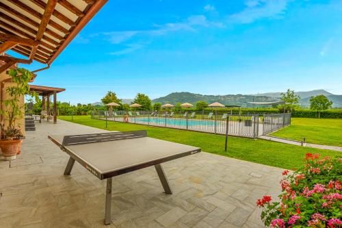 a patio with a table and a swimming pool at VISTALAGO VERSILIA in Massarosa