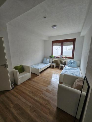 a living room with two beds and a couch at Urban Stay Neu-Ulm in Neu Ulm