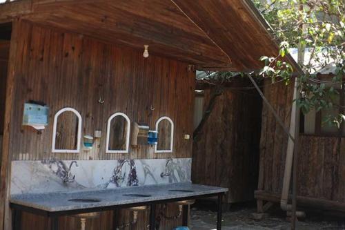 a wooden building with a counter and a table at Bayrams Tree Houses in Olympos