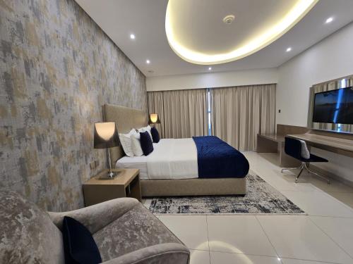 a bedroom with a bed and a flat screen tv at Quill Residence at Paramount Towers 3 BR Creek View in Dubai
