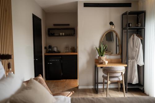 a bedroom with a desk and a mirror and a table at Doria Luxury Boutique Hotel in Dishon