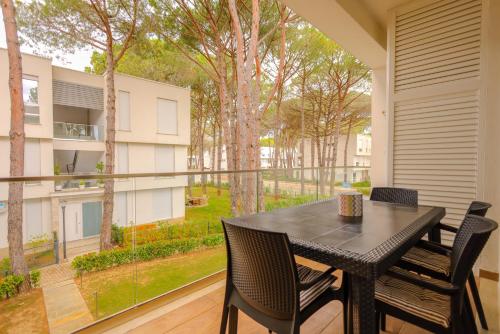 a black table and chairs on a balcony with a view at SanPietro Vacation Apartments in Durrës