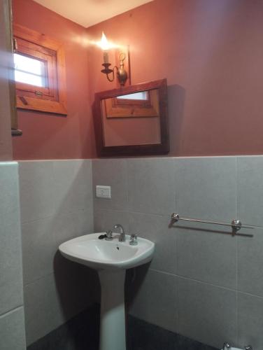 a bathroom with a sink and a mirror at Casa Encantada in Aguas Verdes