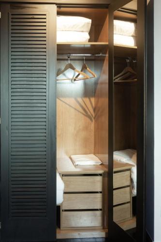 a walk in closet with wooden cabinets and drawers at La Plaza in Hervás