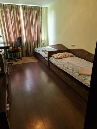 a bedroom with two beds and a desk and a chair at freeparking apartment in Vilnius