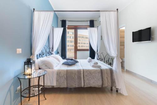 a bedroom with a bed and a window and a table at Suite Laterani 3 bedrooms with parking in Rome