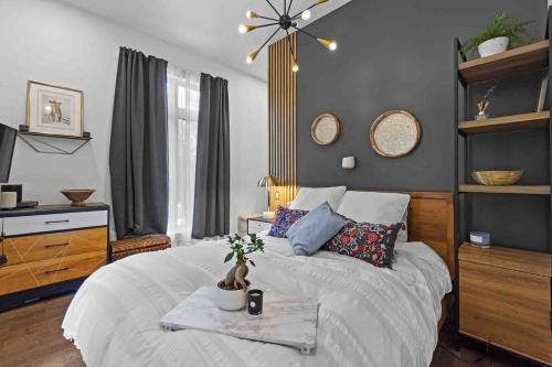 a bedroom with a bed and a table with flowers on it at Chalet moderne et chaleureux in Grandes-Piles