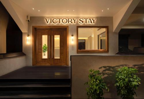 a victory stay sign on the front of a building at Victory Stay in Chennai