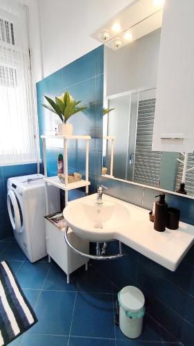 a bathroom with a sink and a toilet and a mirror at Lavender - City Room with free parking in Pula
