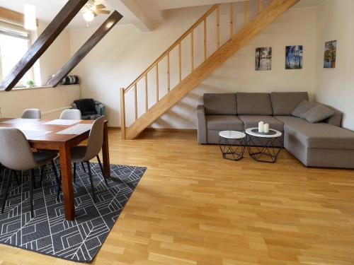a living room with a table and a couch at Õhtukese Apartment in Pärnu