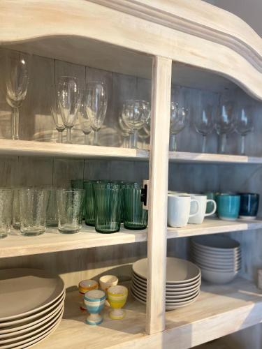 a cabinet filled with glasses and plates and bowls at Ca’Benvenuto in Doische