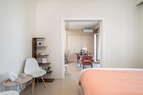 a bedroom with a bed and a table and chairs at Houseloft Skyline Panorama in Thessaloniki