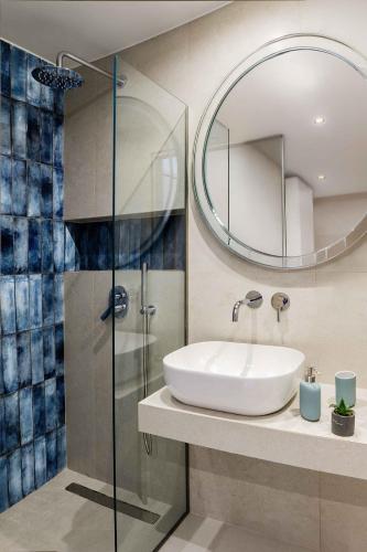 a bathroom with a sink and a mirror at The View Suites Preveza in Preveza