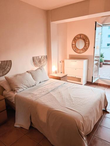 a bedroom with a large bed and a mirror at Rooftop 24 in Calpe