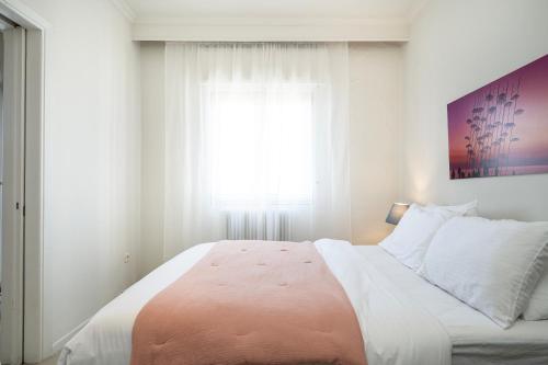 a bedroom with a large bed with a window at Houseloft Skyline Panorama in Thessaloniki