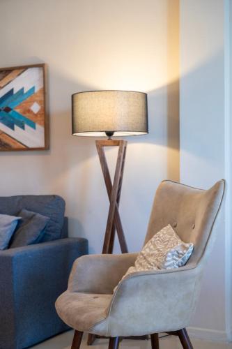 a living room with a chair and a lamp at Houseloft Skyline Panorama in Thessaloniki