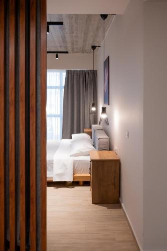 a bedroom with a white bed and a window at Never Space Up Apartment Piraeus Center Port Stay in Piraeus