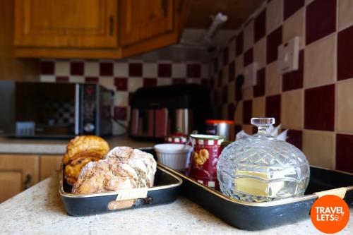 two pans of pastries on a counter in a kitchen at 5BR Farmhouse By Travel Lets Holiday Rentals Donegal in Carrigart