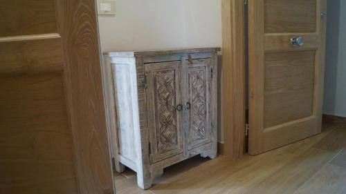 a wooden cabinet in a room next to a door at Terra Vitale in Cava deʼ Tirreni