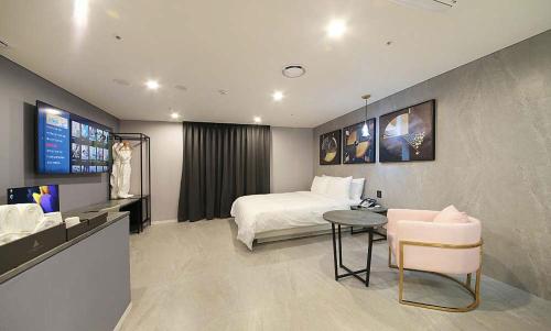 a hotel room with a bed and a table at Restia Incheon Bay Hotel in Incheon