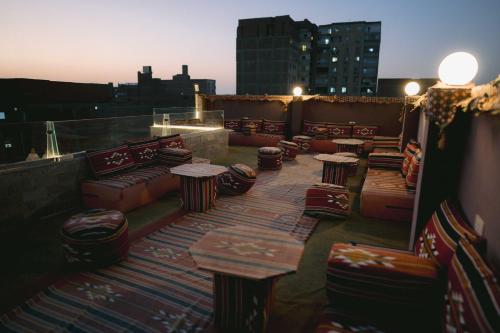 a row of tables and chairs on a rooftop patio at Tuya pyramids hotel in Cairo