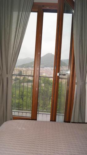 a bedroom with a bed and large glass windows at Terra Vitale in Cava deʼ Tirreni