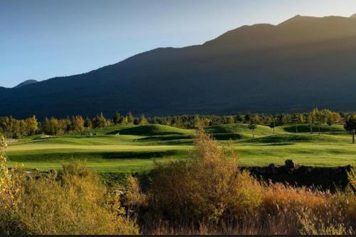 a view of a golf course with mountains in the background at Apartment 78 by the pool in Bansko